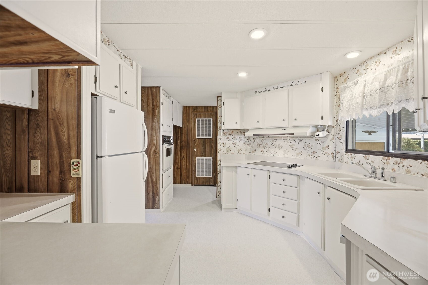 620 112th Street Southeast, Unit 205 Everett, WA 98208 - Photo 11 of 34 a kitchen with white cabinets and white stainless steel appliances