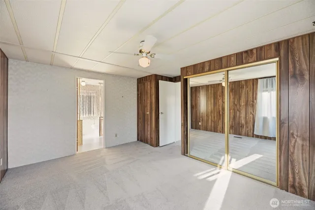 a bathroom with a granite countertop sink a mirror and a shower