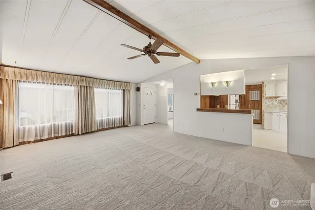 a view of an empty room with windows