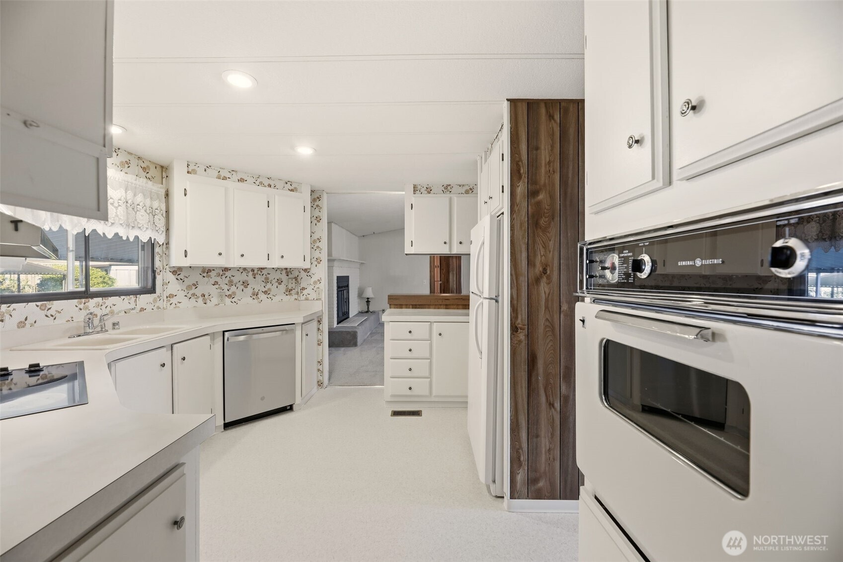 620 112th Street Southeast, Unit 205 Everett, WA 98208 - Photo 9 of 34 a kitchen with granite countertop white cabinets and white appliances