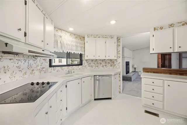 a kitchen with white cabinets and white stainless steel appliances