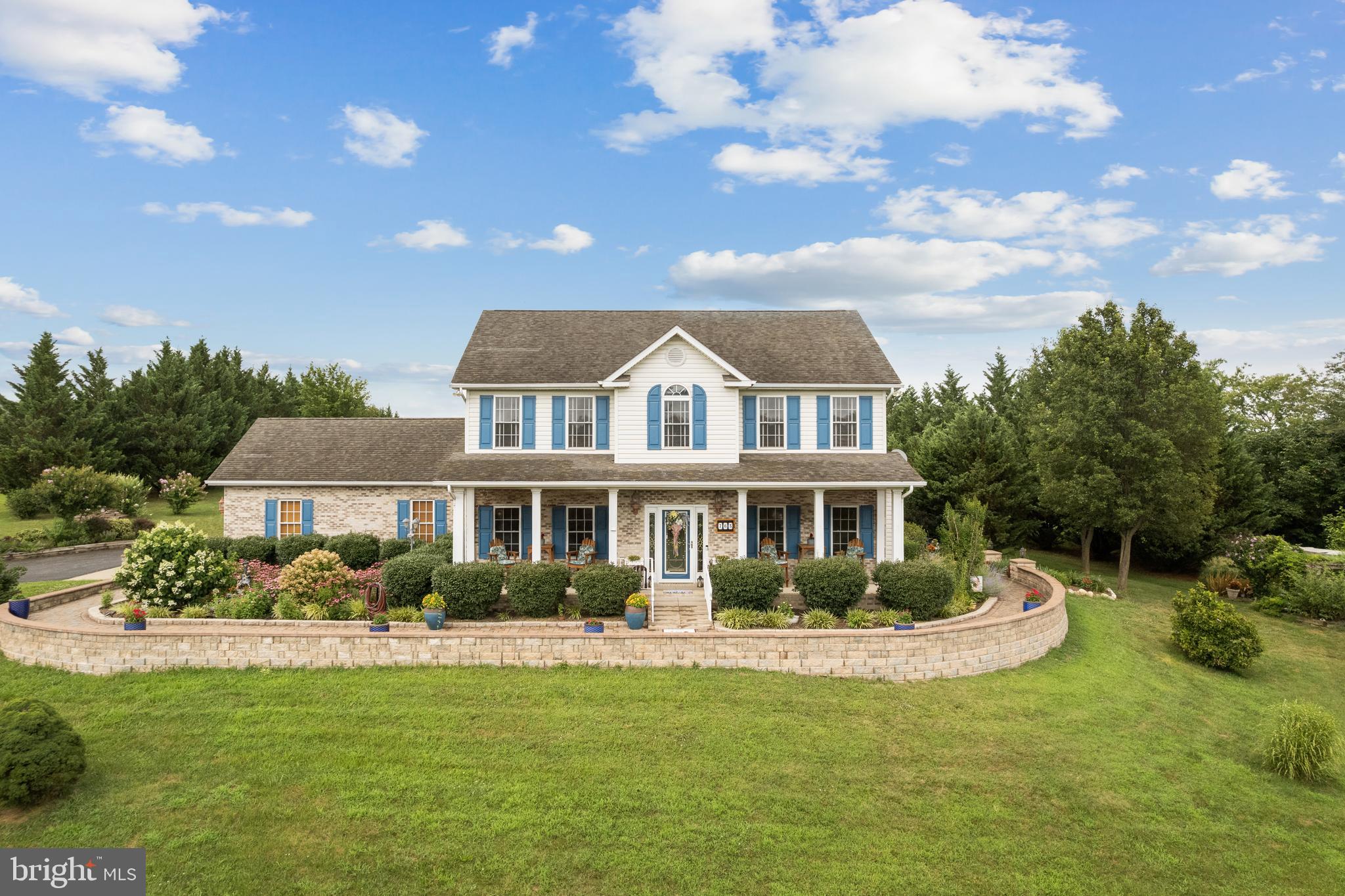 765 Gun Club Road Stephenson, VA 22656 - Photo 1 of 113 a front view of a house with a garden and trees