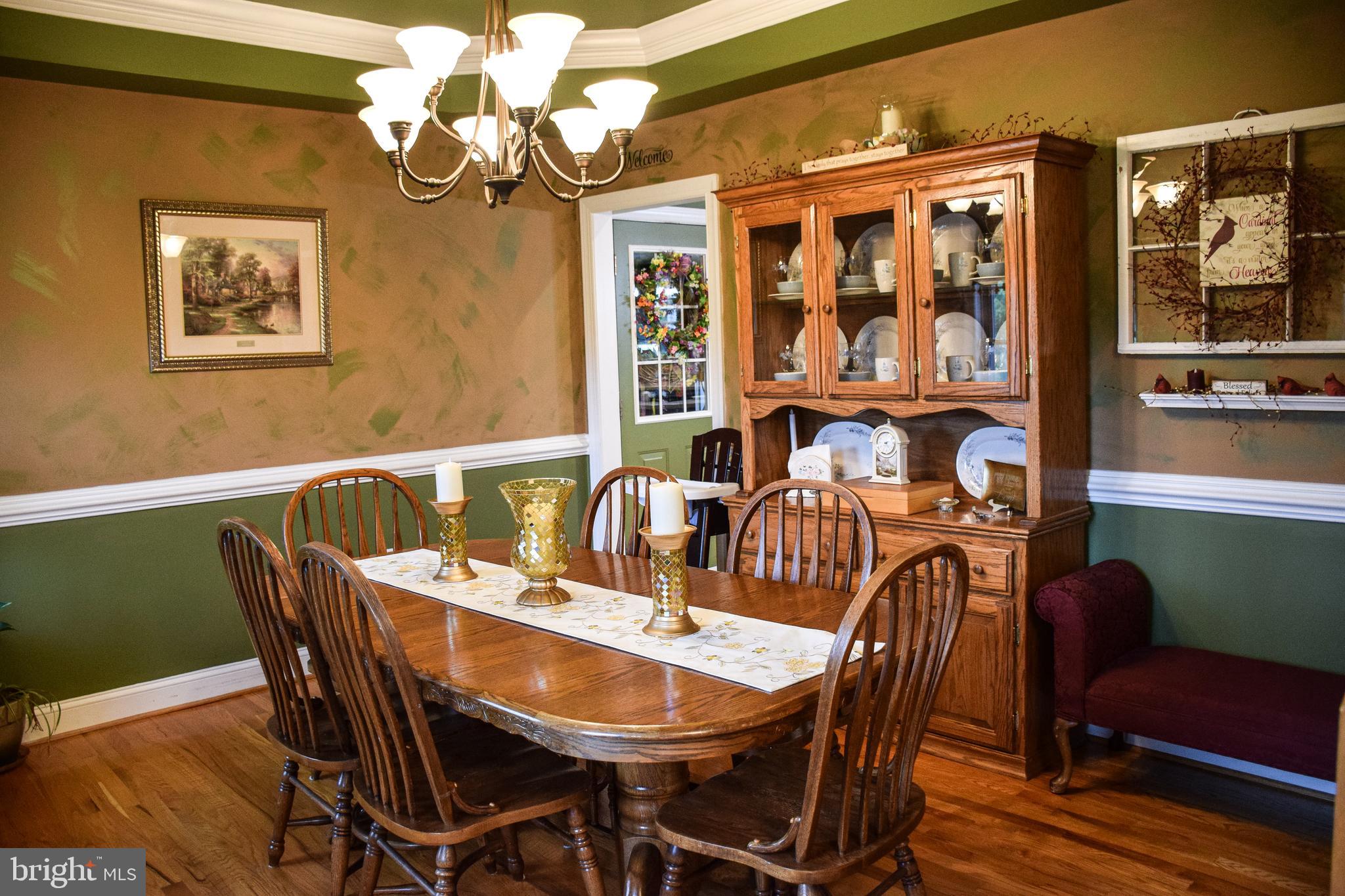 765 Gun Club Road Stephenson, VA 22656 - Photo 16 of 113 a view of a dining room with furniture wooden floor and chandelier