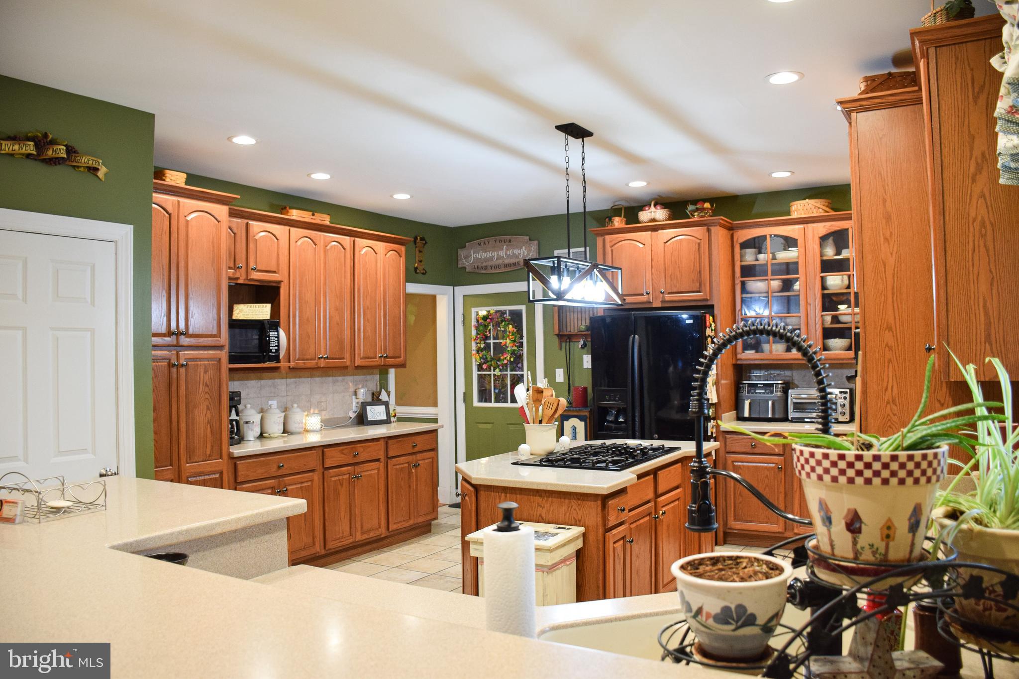 765 Gun Club Road Stephenson, VA 22656 - Photo 22 of 113 a kitchen with stainless steel appliances kitchen island granite countertop a sink and cabinets