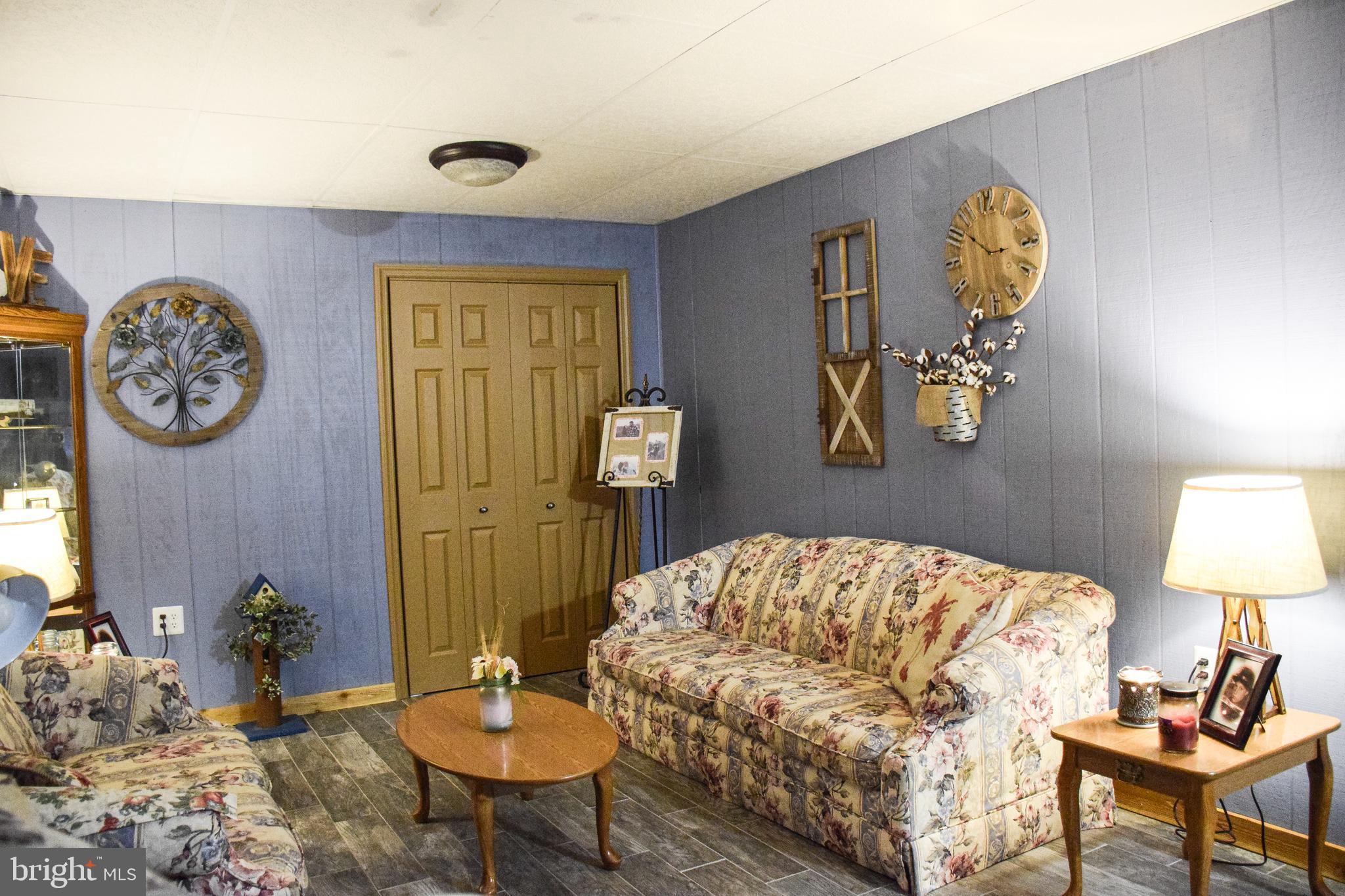 765 Gun Club Road Stephenson, VA 22656 - Photo 58 of 113 a living room with a couch and chandelier