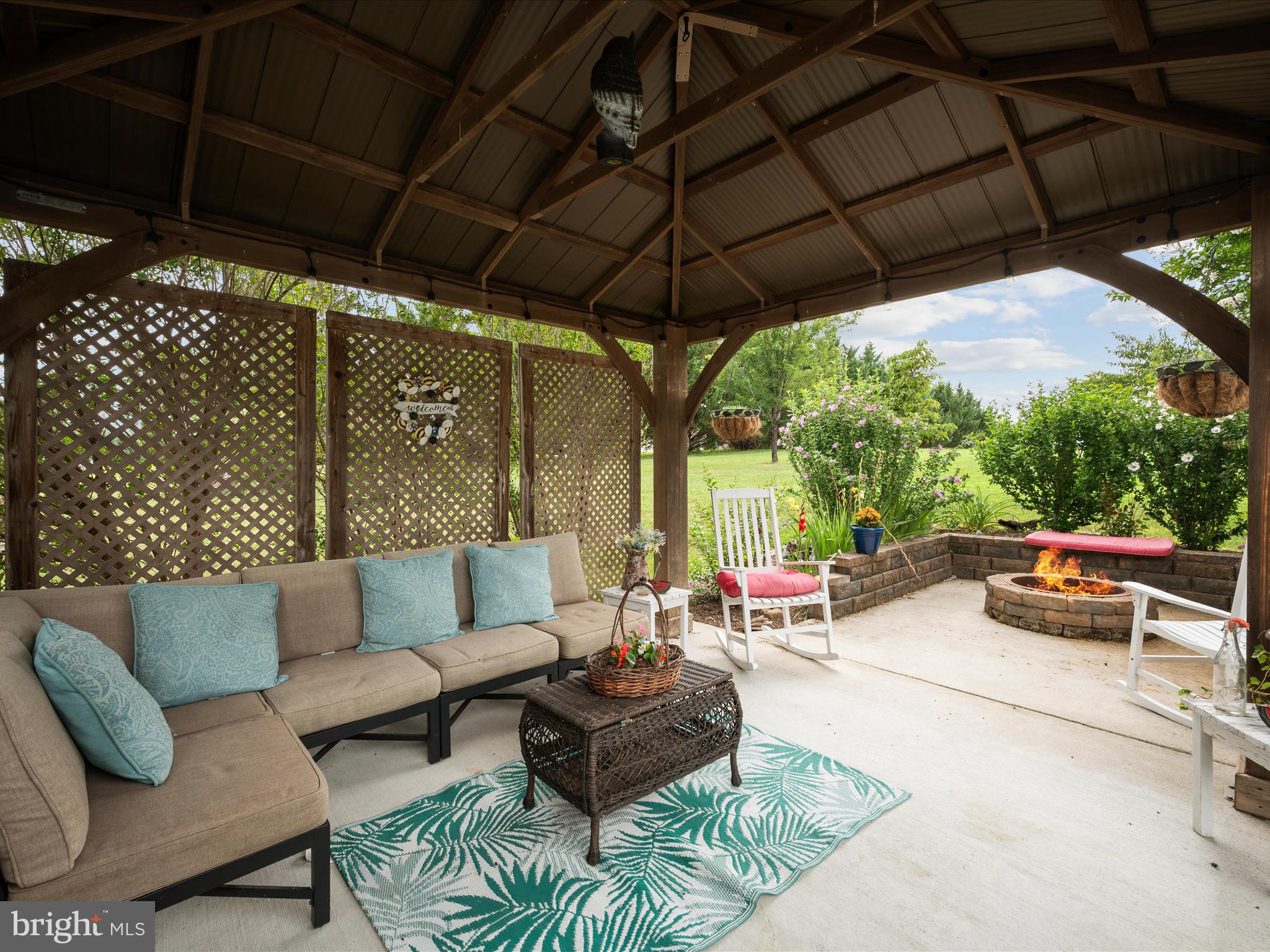 765 Gun Club Road Stephenson, VA 22656 - Photo 7 of 113 a view of patio with couches and a umbrella