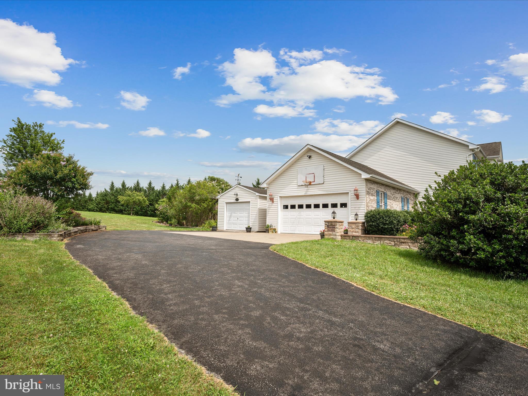 765 Gun Club Road Stephenson, VA 22656 - Photo 73 of 113 a view of a house with a yard and garage