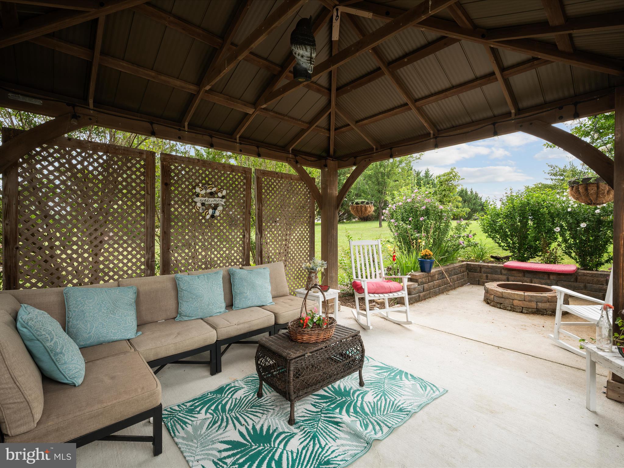 765 Gun Club Road Stephenson, VA 22656 - Photo 82 of 113 a view of a patio with couches and a umbrella