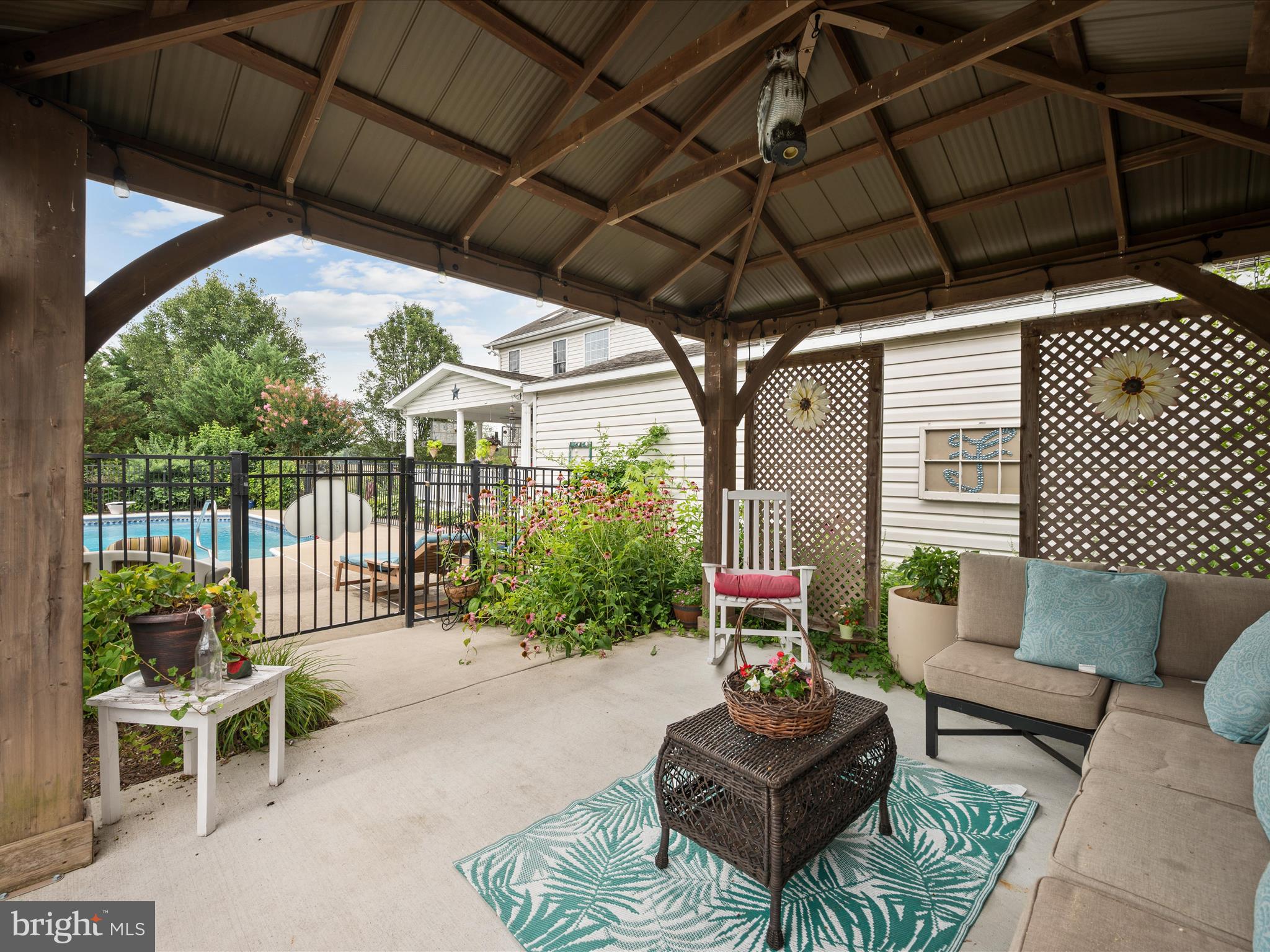 765 Gun Club Road Stephenson, VA 22656 - Photo 83 of 113 a outdoor living space with furniture and a black umbrella