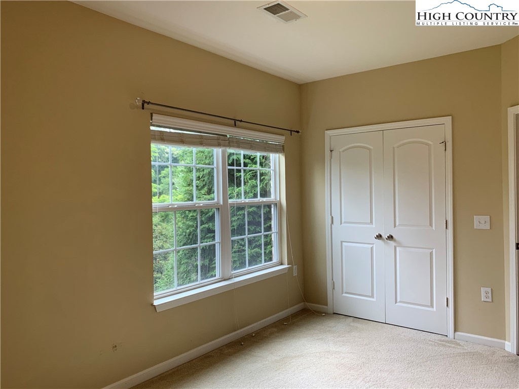190 Eli Hartley Drive, Unit 210 Boone, NC 28607 - Photo 14 of 19 an empty room with windows