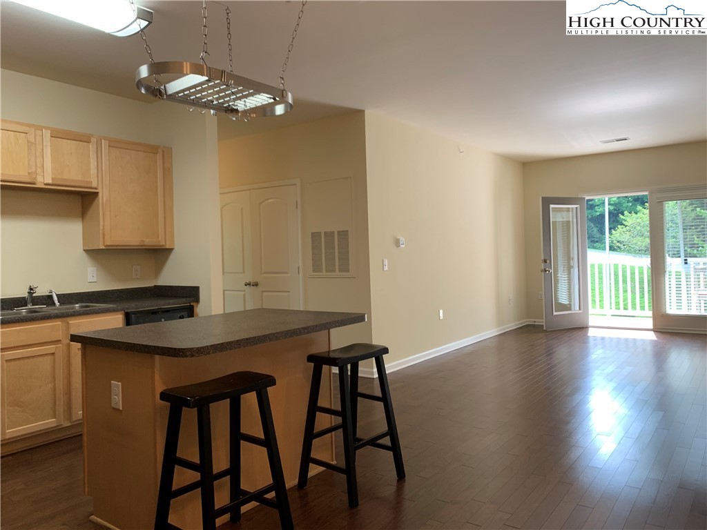 190 Eli Hartley Drive, Unit 210 Boone, NC 28607 - Photo 3 of 19 a kitchen that has a table chairs and wooden floor