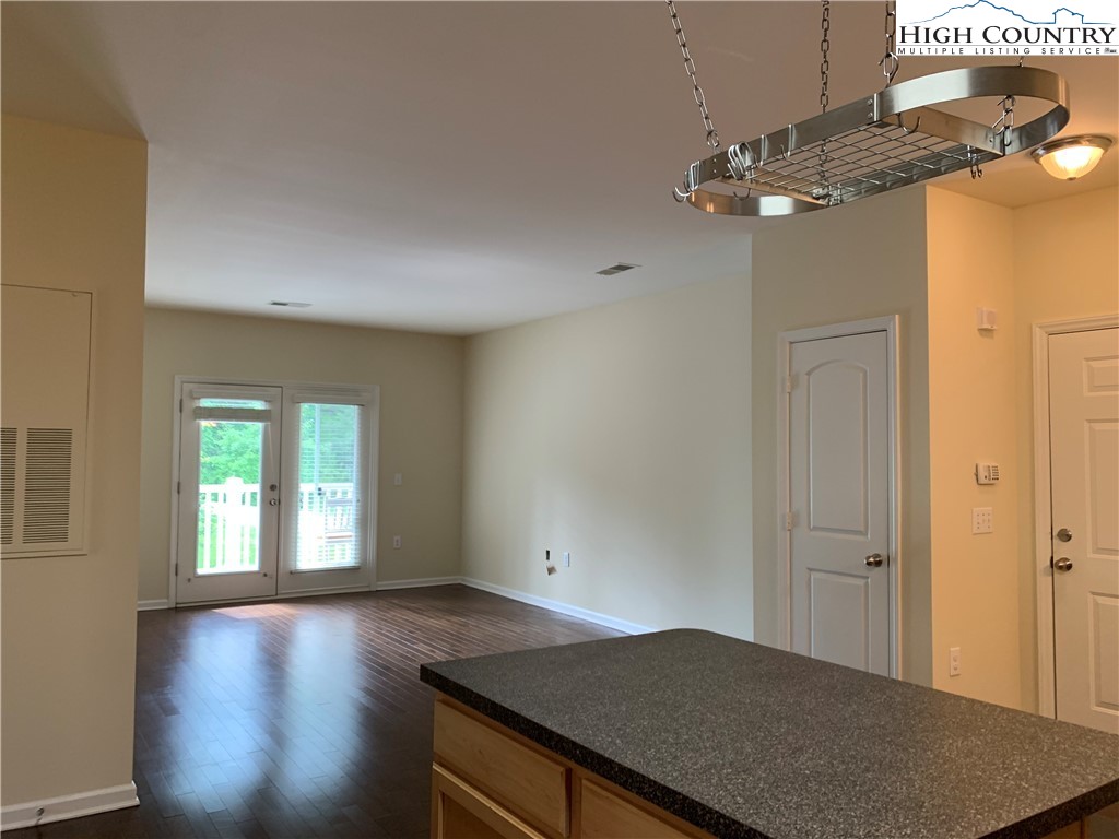 190 Eli Hartley Drive, Unit 210 Boone, NC 28607 - Photo 5 of 19 wooden floor in an empty room with a window