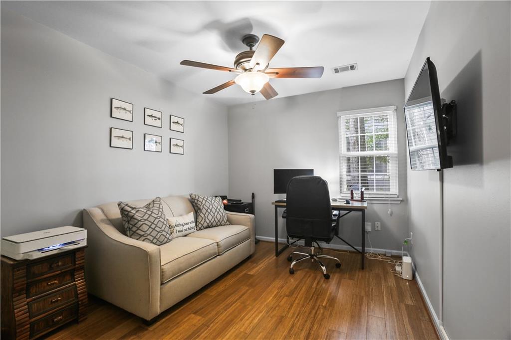 920 Bridge Pointe Court Alpharetta, GA 30005 - Photo 11 of 18 a living room with furniture and a flat screen tv