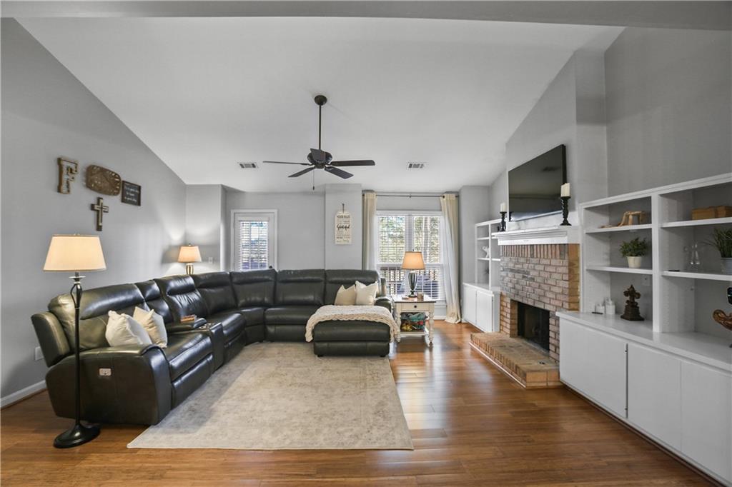 920 Bridge Pointe Court Alpharetta, GA 30005 - Photo 12 of 18 a living room with furniture and a flat screen tv