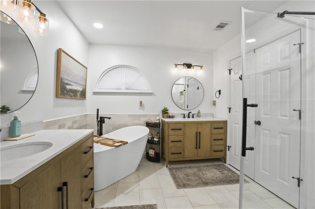 920 Bridge Pointe Court Alpharetta, GA 30005 - Photo 16 of 18 a spacious bathroom with a tub sink and mirror