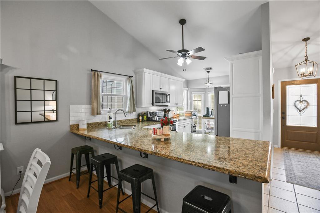 920 Bridge Pointe Court Alpharetta, GA 30005 - Photo 6 of 18 a large kitchen with granite countertop lots of counter top space