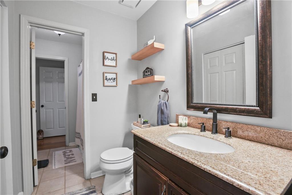 920 Bridge Pointe Court Alpharetta, GA 30005 - Photo 10 of 18 a bathroom with a granite countertop sink toilet and shower