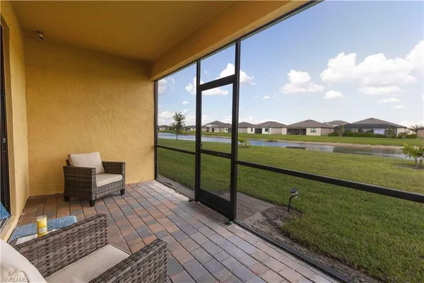 a view of a balcony with lake view and wooden floor