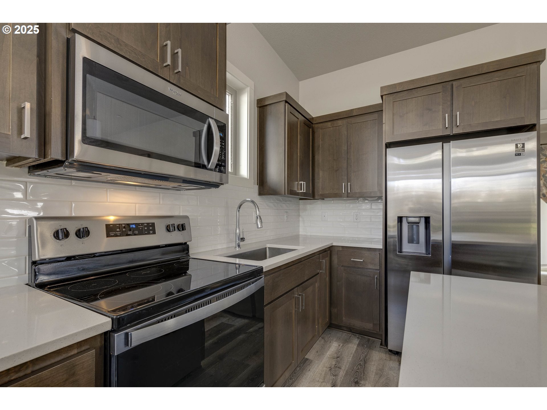 1821 Cousteau Loop Southeast Salem, OR 97302 - Photo 12 of 27 a kitchen with stainless steel appliances a sink stove and microwave