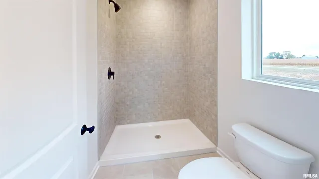 a bathroom with a toilet and bathtub