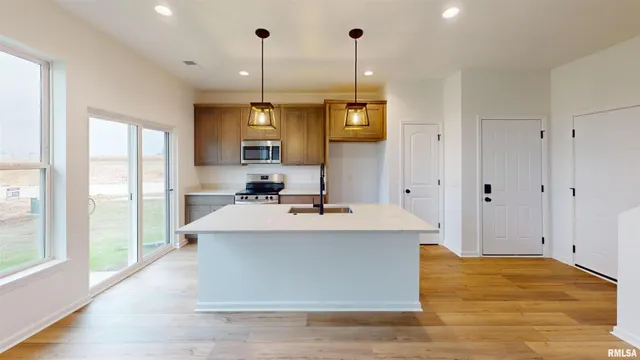 a kitchen with granite countertop wooden cabinets and a stove top oven