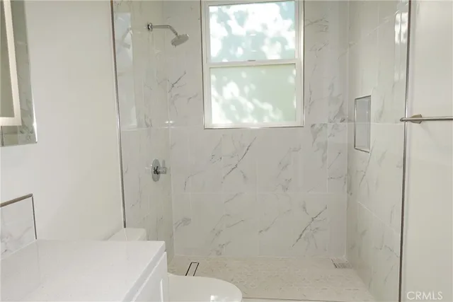 a bathroom with a toilet and a shower