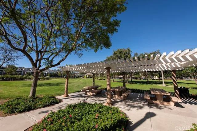 a view of a house with a big yard and palm trees