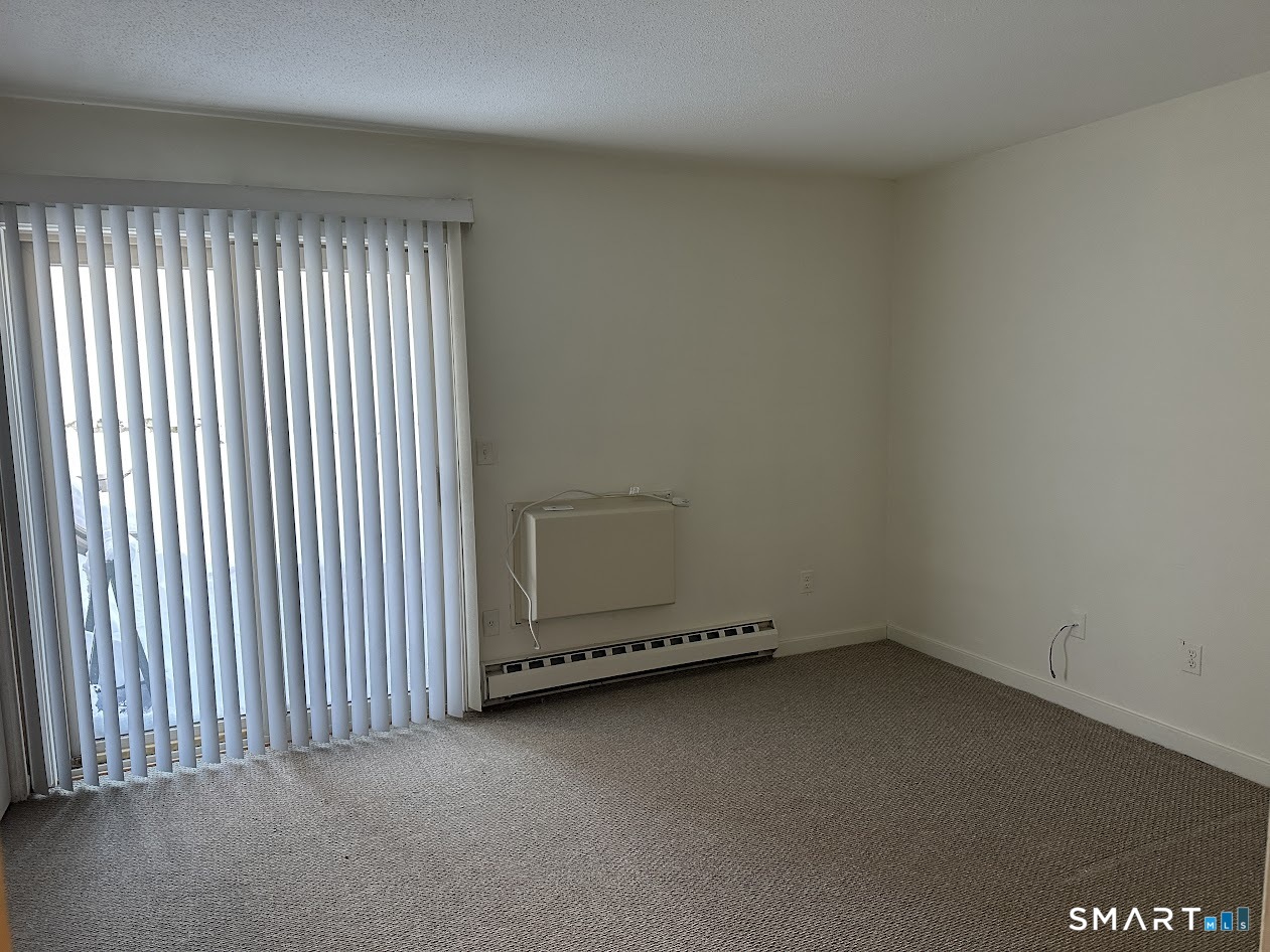 295 Redstone Hill Road, Unit 3 Bristol, CT 06010 - Photo 4 of 13 an empty room with a empty space and window