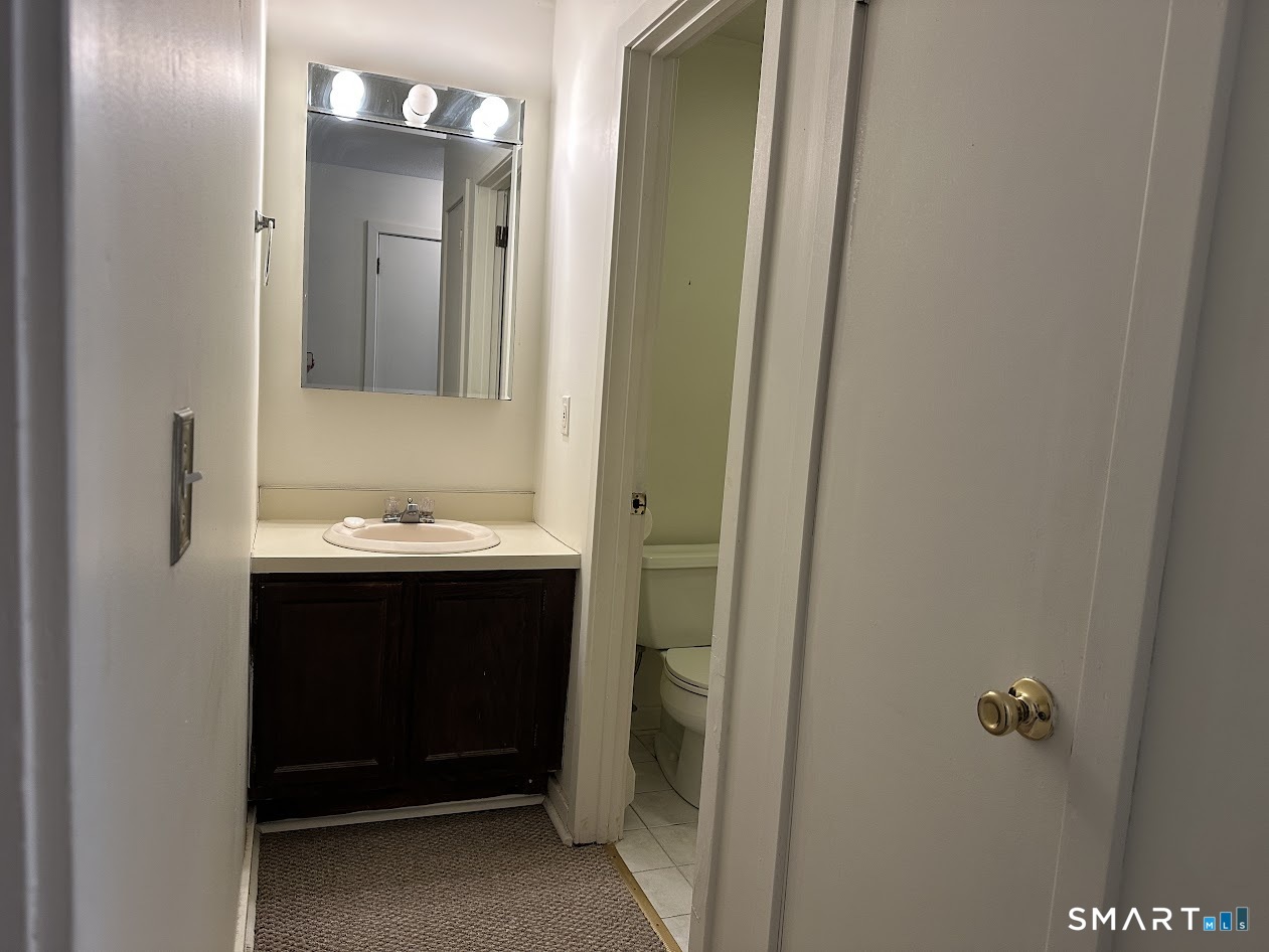 295 Redstone Hill Road, Unit 3 Bristol, CT 06010 - Photo 5 of 13 a bathroom with a sink and mirror