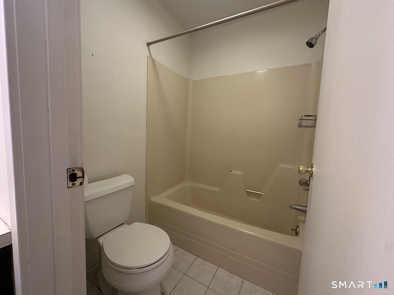 295 Redstone Hill Road, Unit 3 Bristol, CT 06010 - Photo 6 of 13 a white toilet sitting next to a bath tub