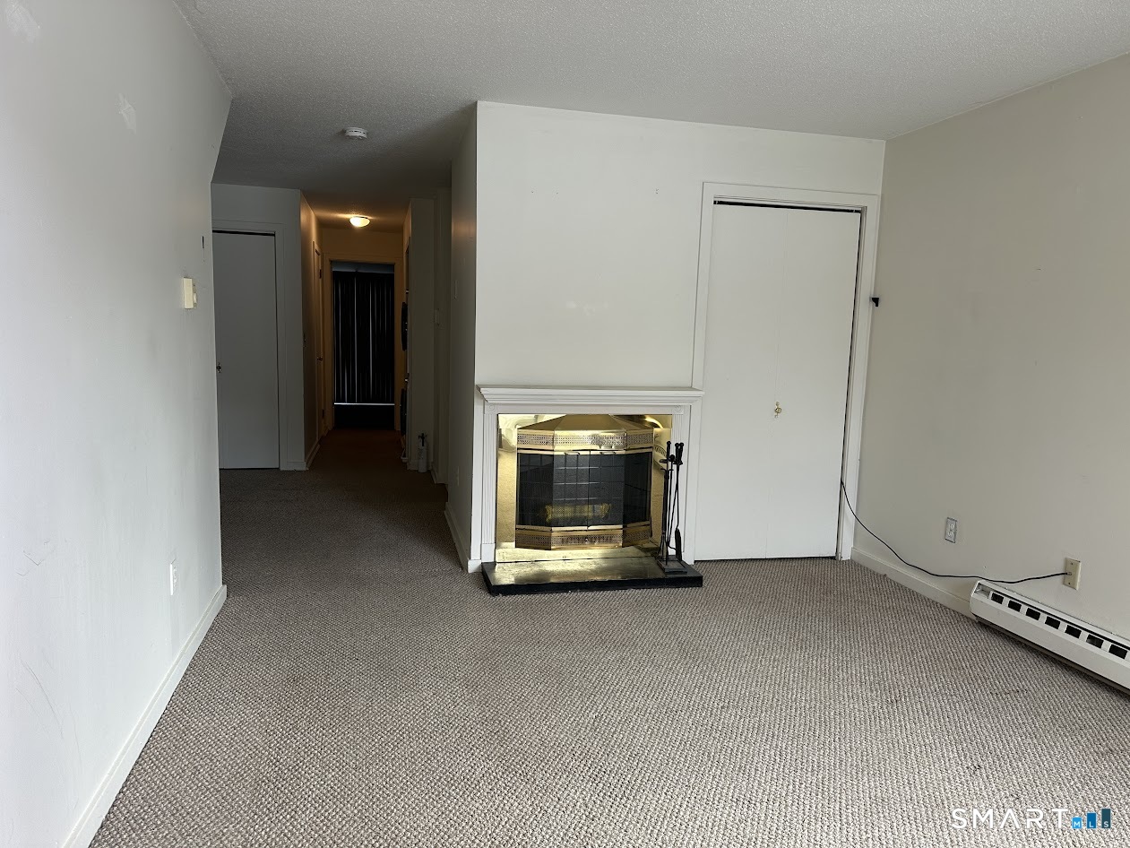 295 Redstone Hill Road, Unit 3 Bristol, CT 06010 - Photo 10 of 13 a room with a flat screen tv