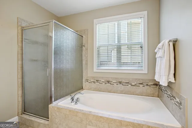 a bathroom with a double vanity sink a mirror and a shower