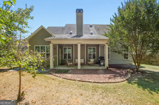 a view of a chair and tables in the patio of the house