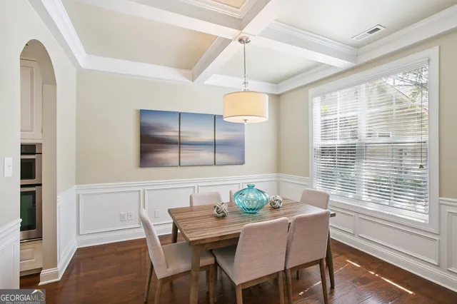 a kitchen with granite countertop a sink chairs and cabinets