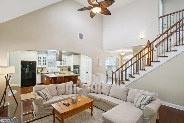 a living room with stainless steel appliances granite countertop furniture and a kitchen view
