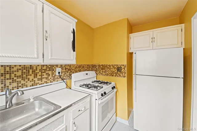 a kitchen with a refrigerator and a sink