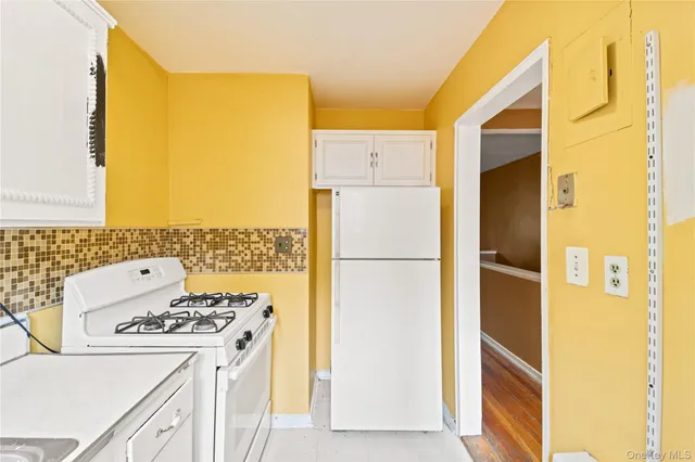 a kitchen with a refrigerator and a stove