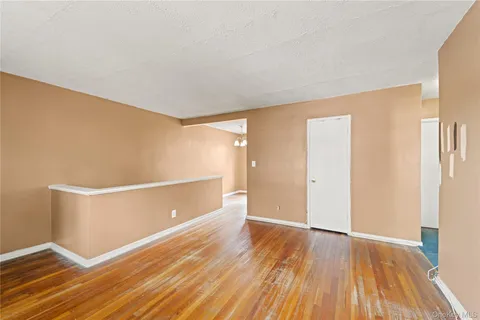 a view of room with window and wooden floor