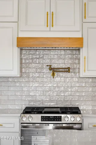 a kitchen with stainless steel appliances a counter top space and cabinets