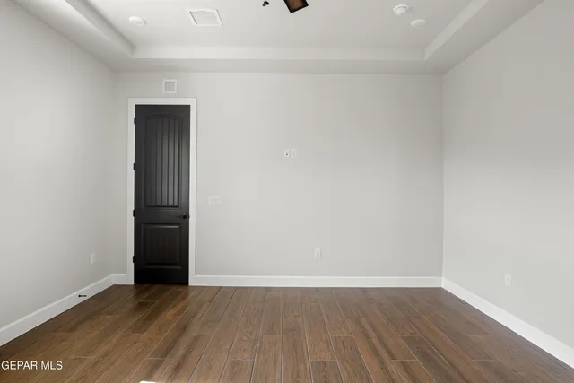 a view of a room with wooden floor and white wall