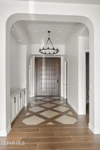 a large white kitchen with a large counter top appliances and cabinets