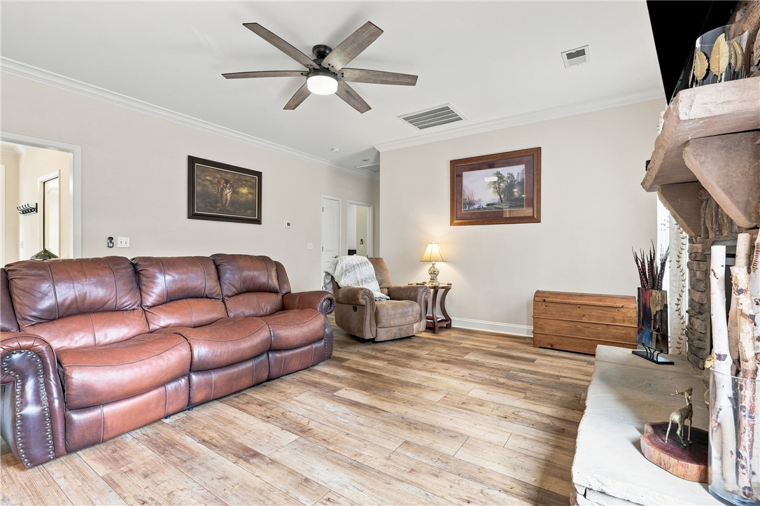 525 Shirley Store Road Anderson, SC 29621 - Photo 15 of 46 Warm wood flooring and classic crown molding highlight this welcoming living space.