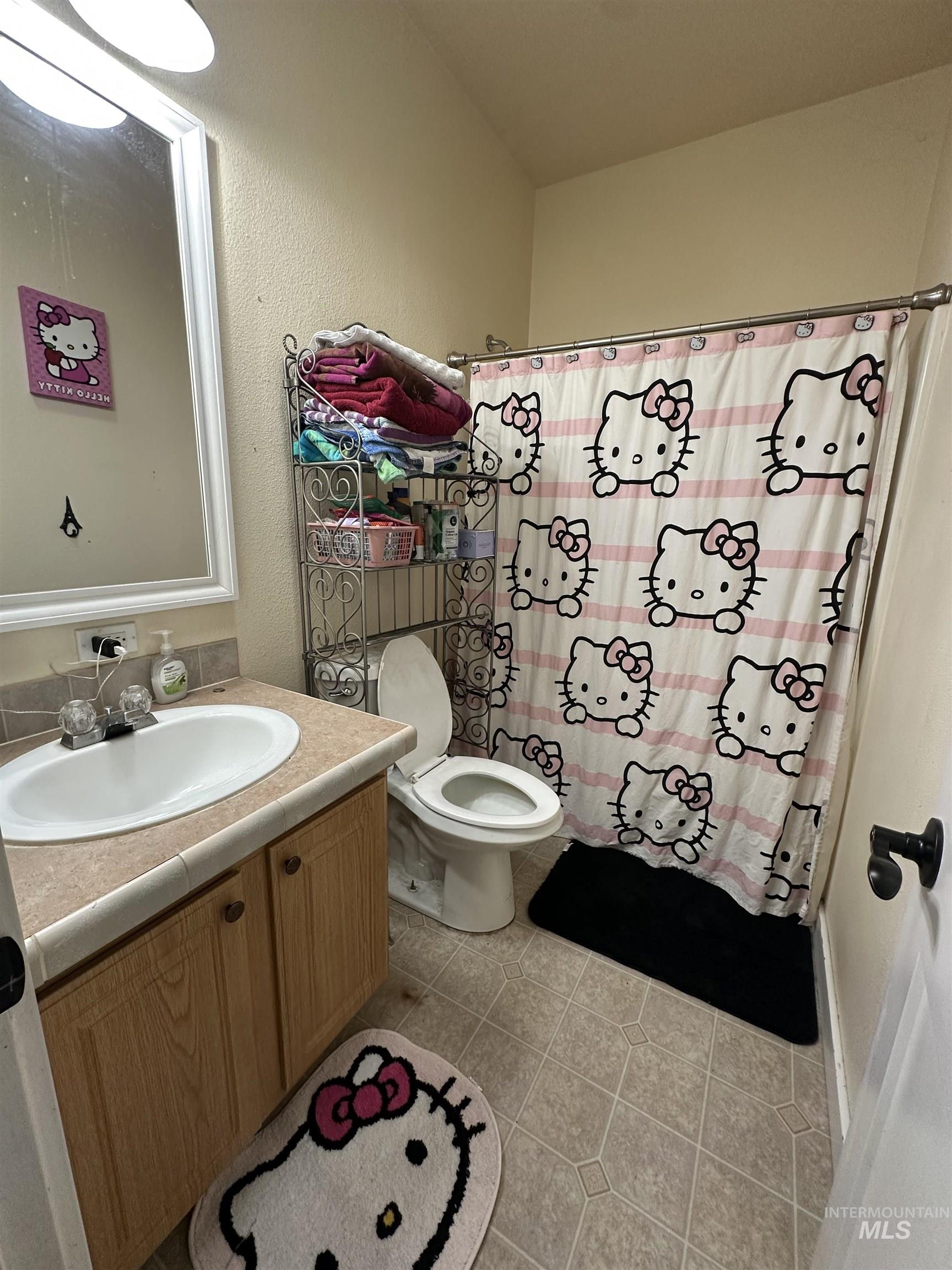 2859 Luke's Gulch Road Stites, ID 83552 - Photo 20 of 48 Full bathroom featuring vanity, light tile patterned floors, a textured wall, and shower / tub combo