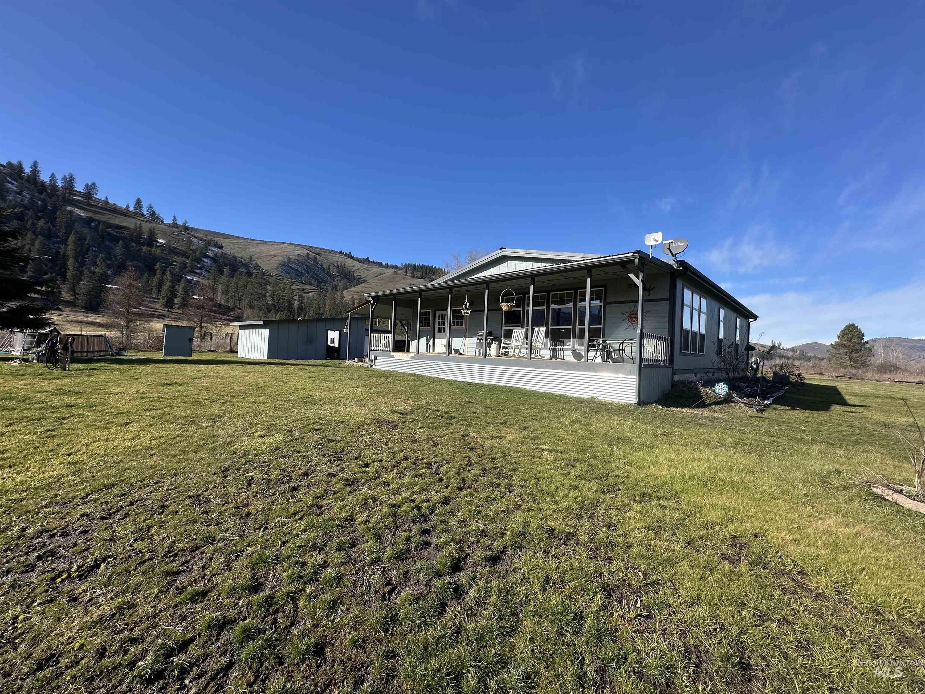 2859 Luke's Gulch Road Stites, ID 83552 - Photo 5 of 48 Rear view of house with a mountain view, a yard, and a sunroom