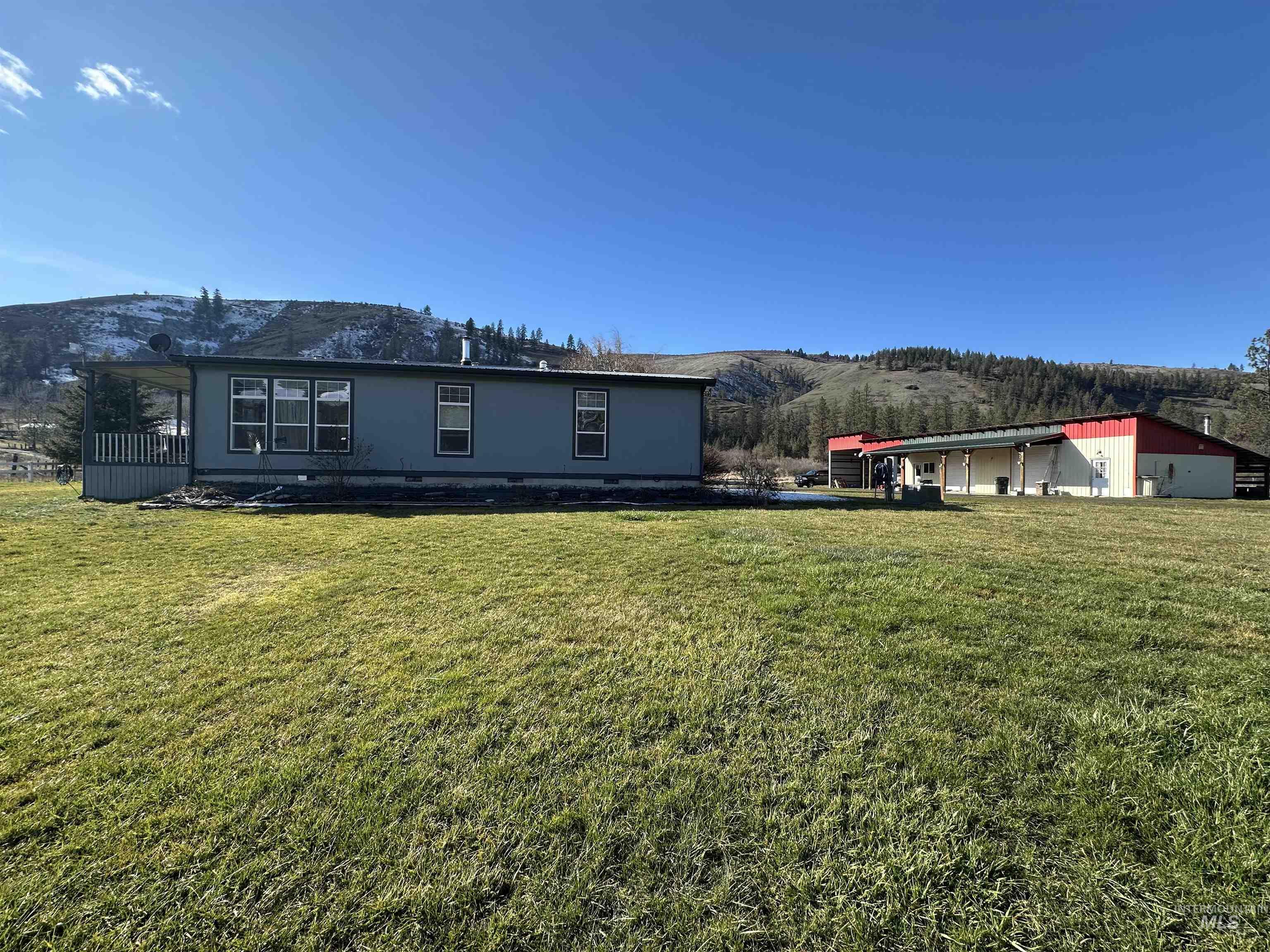 2859 Luke's Gulch Road Stites, ID 83552 - Photo 7 of 48 Back of house featuring a mountain view and a yard