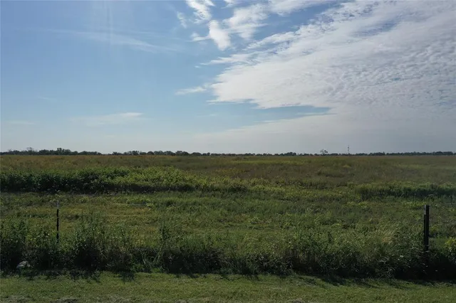 a view of a lake and green valley
