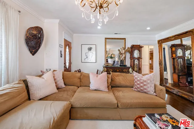 a living room with furniture and a chandelier