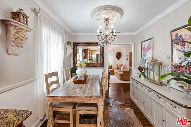 a view of a dining room with furniture a chandelier and wooden floor