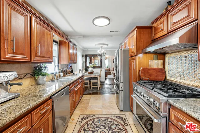 a kitchen with stainless steel appliances granite countertop a stove and a sink