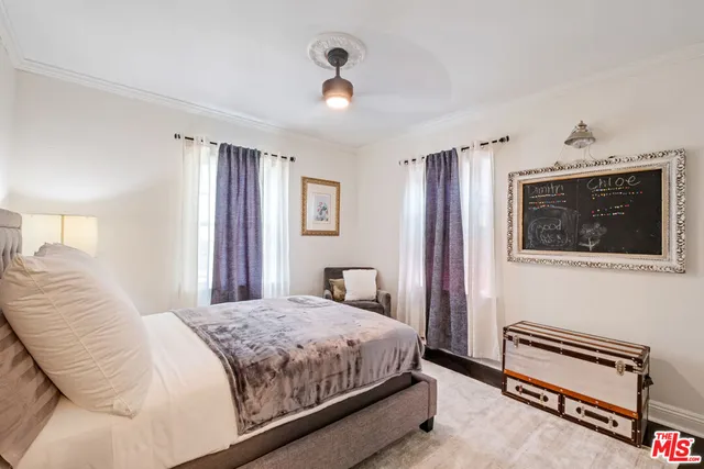 a bedroom with a bed and a tv